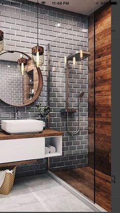 a bathroom with a sink, mirror and shower stall in it's center area