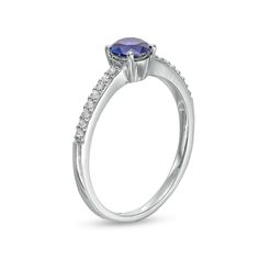 A simple look with vibrant color, this fashion ring suits her minimalist style. Crafted in sterling silver, this design showcases a 5.0mm bright blue lab-created sapphire at the center. Petite white lab-created sapphires glisten along the shank for a subtle touch of shimmer. Buffed to a brilliant luster, this ring is a lovely addition to her jewelry box. Blue Solitaire Birthstone Ring, Blue Solitaire Birthstone Ring With Round Stone, Blue Solitaire Birthstone Ring With Round Band, Modern Diamond Ring With Birthstone In Round Band, Classic Blue Birthstone Ring With Round Stone, Classic Tanzanite Birthstone Promise Ring, Blue Solitaire Diamond Ring For Promise, Modern Sapphire Birthstone Ring For Promise, Blue Solitaire Diamond Promise Ring