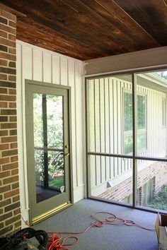 an empty room with sliding glass doors on the outside and carpeted floor in front