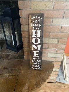 a wooden sign sitting on top of a table next to a brick wall and fireplace