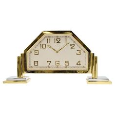 a gold and white clock sitting on top of each other