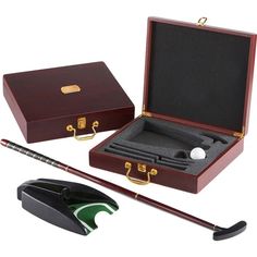 a wooden box with a golf club and ball in it next to a black object