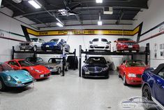 a garage filled with lots of different colored cars