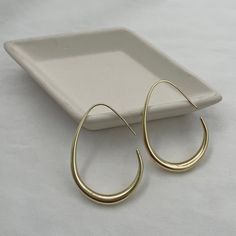 Upgrade your earring game with our sleek Geometrical Hoop earrings. These hoops are sure to make a statement with their timeless design and sturdy build. Perfect for everyday wear and a must-have for any jewelry collection. From sunup to sundown, these will become a favorite! available in gold or silver plated metal 1 and 1/2 inch drop lightweight for everyday wear Modern Everyday Small Hoop Earrings, Modern Metal Teardrop Earrings, Modern Small Hoop Teardrop Earrings For Pierced Ears, Trendy Teardrop Metal Hoop Earrings, Modern Small Hoop Metal Earrings, Modern Metal Hoop Earrings For Everyday, Modern Metal Hoop Earrings For Everyday Wear, Minimalist Metal Hoop Wrap Earrings, Modern Nickel-free Hoop Earrings For Everyday