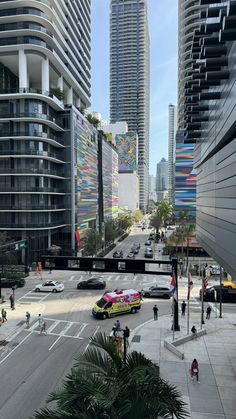 a city street filled with lots of traffic and tall buildings