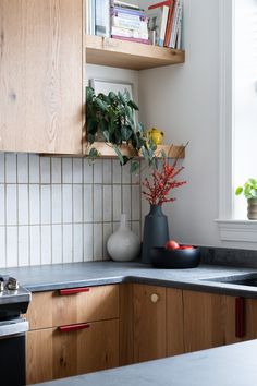 the kitchen counter is clean and ready to be used as a vase with flowers in it