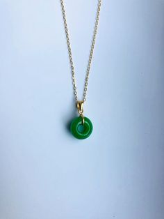 A piece of charming & elegant dark green jade necklace, which is made with genuine 100% natural real green jade donut and 18k gold plated necklace. A great combination of modernness and vintages. The simple and elegant design adds a spark to your daily wear or a bit of charm for your date night. Perfect as a gift for your loved ones or just treat yourself. Some Highlights of this dark green genuine jade circle pendant are: ＊High-quality Material Only 100% natural Chinese green round jade pai Minimalist Jade Round Pendant Jewelry, Minimalist Jade Round Pendant Necklace, Minimalist Green Round Bead Necklaces, Minimalist Green Necklace For May Birthstone, Jade Necklace For May Birthstone, Green Circular Jewelry Gift, Green Round Pendant Necklace For May Birthstone, Green May Birthstone Round Pendant Necklace, Green Round Minimalist Jewelry