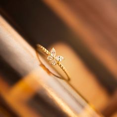 a diamond ring sitting on top of a wooden table