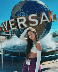 a woman standing in front of a sign that says versa