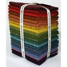 a stack of multicolored cloths stacked on top of each other in different colors