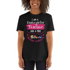 Kindergarten Teacher Shirt for Mom Funny Mother Kindergarten Teacher Gift Humor Preschool Teacher Mom Shirt PreK Teacher Gift for Mother You've now found the staple t-shirt of your wardrobe. It's made of a thicker, heavier cotton, but it's still soft and comfy. And the double stitching on the neckline and sleeves add more durability to what is sure to be a favorite! * 100% ring-spun cotton * Sport Grey is 90% ring-spun cotton, 10% polyester * Dark Heather is 65% polyester, 35% cotton * 4.5 oz/y² Back To School Black Cotton Tops, Black Cotton Tops For Back To School, Student Letter Print Short Sleeve Shirt, Student Short Sleeve Shirt With Letter Print, Black Text Print Shirt For School, School Shirt With Funny Text In Cotton, Casual Short Sleeve Shirt For Teaching, Black Text Print Top For Teaching, Black Top With Text Print For Teaching