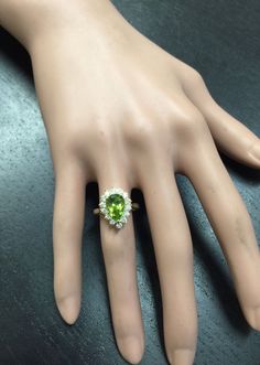 3.20 Carats Natural Very Nice Looking Peridot and Diamond 14K Solid Yellow Gold Ring Suggested Replacement Value: $5,300.00 Total Natural Pear Shaped Peridot Weight is: Approx. 2.50 Carats Peridot Measures: Approx. 11 x 7mm Natural Round Diamonds Weight: Approx. 0.70 Carats (color G-H / Clarity SI1-SI2) Ring total weight: 4.9 grams Ring total weight: Approx. 1.6 grams Disclaimer: all weights, measurements and colors are approximate and may vary slightly from the listed dimensions or as seen in t Oval Peridot Jewelry For Formal Occasions, Formal Peridot Diamond Ring With Center Stone, Classic Peridot Jewelry For Formal Occasions, Peridot Ring For Formal Occasions, Peridot Rings For Formal Occasions, Fine Jewelry Peridot For Formal Occasion, Green Gemstones In 14k Gold For Wedding, Wedding Jewelry With Peridot In Halo Setting, Formal Fine Jewelry With Peridot