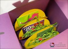 there are three yellow plates with green leaves on them in a purple and pink box