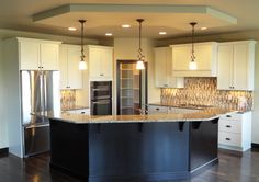 a large kitchen with an island in the middle