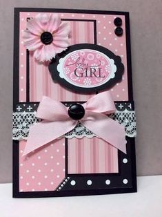 a pink and black card with a flower on the front that says, it's a girl