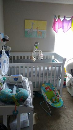 a baby's room with two cribs and toys