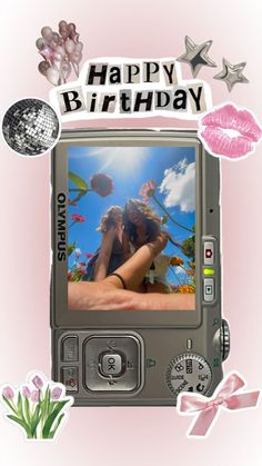 a digital camera with the words happy birthday on it's screen and some flowers