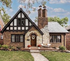 a brick house with an american flag on the front lawn