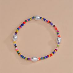 This colorful ankle bracelet features a series of bright small beads interspersed with pearl accents. 8.66" L Howlite / pearl Adjustable Multicolor Pearl Bracelet With Colorful Beads, Casual Colorful Beads Anklets For Spring, Casual Colorful Beaded Anklets For Spring, Casual Colorful Beaded Spring Anklets, Spring Anklets With Colorful Beads, Casual Pearl Beaded Bracelets, Trendy Multicolor Pearl Bracelet For The Beach, Trendy Multicolor Pearl Bracelet With Colorful Beads, Trendy Multicolor Pearl Bracelet For Beach