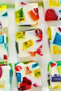 many different colored pieces of soap on a white surface with green, yellow, red, and blue squares