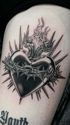 a black and white tattoo with a heart surrounded by barbed wire