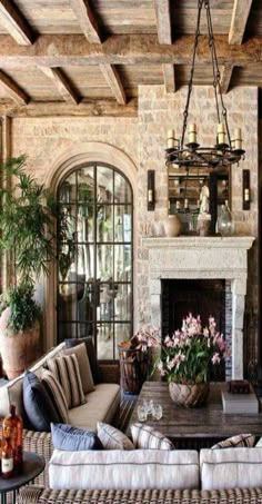 a living room filled with furniture and a fire place in the middle of a room