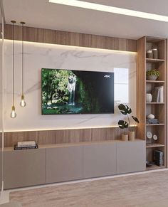 a living room with a large flat screen tv mounted on the wall above it's entertainment center