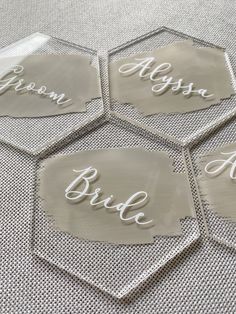 four clear coasters with the word bride written on them