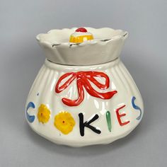 a ceramic cookie jar with the word cake painted on it