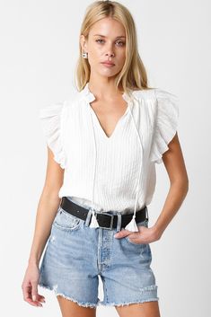 Rock a fashion win with The Stevie Top! Featuring a flouncy v-neckline and sweet white shade, you'll be feelin' extra fancy in this top that's perfect for any event - whether you're on the clock or out on the town. Slacks for the day, denim for the evening! Details+ Fit 100% Polyester Runs True to Size Hand Wash Cold Hang Dry Ruffle V-Neckline Front Tassel Ties Ruffle Short Sleeves White | Solid Model is 5'9" and wearing a size Small Ruffle Sleeve Top, Ruffle Sleeve Blouse, White Solid, Rock A, Ruffled Sleeve Top, Ruffle Shorts, Ruffle Top, V Neck Tops, T Shirt Top