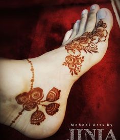 the foot is decorated with henna designs