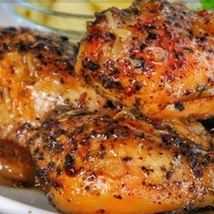 grilled chicken on a white plate with garnishes