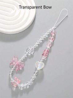 a pair of pink and white beads with bows on them