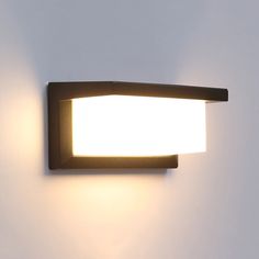 a close up of a light on a wall in a room with white walls and flooring