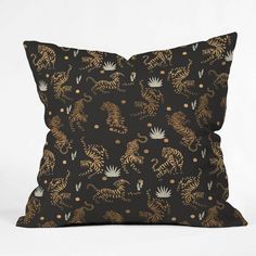 a black pillow with gold tiger designs on it