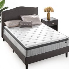 an image of a mattress and night stand