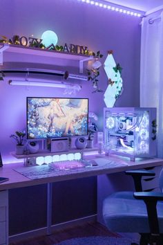 a desk with a computer monitor, keyboard and mouse on it in front of a purple wall