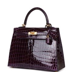 This Sellier Kelly is in Aubergine shiny Niloticus crocodile with gold hardware and has tonal stitching, front flap, two straps with center toggle closure, clochette with lock and two keys, single rolled handle and removable strap. The interior is lined with Aubergine chevre and has a zip pocket with an Hermes engraved zipper pull and two open pockets on the opposite side. Collection: UOrigin: FranceCondition: New (Plastic on hardware)Accompanied by: Hermes box, Hermes dustbag, clochette, lock, Hermes Kelly Sellier, Hermes Kelly 25, Kelly Sellier, Peter Lindbergh, Hermes Box, Birkin 25, Hermes Bags, Vintage Handbags, Birkin Bag