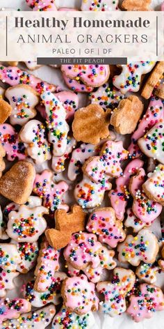 a pile of frosted animal crackers with sprinkles and hearts on them