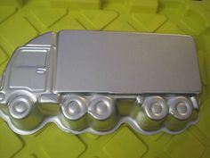 an image of a truck cookie mold on yellow background with white circles and black dots