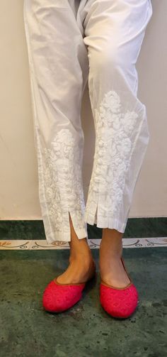 Relaxed Fit Cotton Pants with opening and button inserts. Embroidered in chikankari by skilled artisans. Length - 38/39 inches Size -  S -  waist stretched fits upto 40 M - waist stretched fits upto 42 L -  waist stretched fits upto 44 XL - waist stretched fits upto 46 XXL - waist stretched fits upto 48/50 Traditional White Bottoms, White Bottoms With Chikankari Embroidery, Traditional White Long Pants, Traditional Fitted Full-length Pants, Fitted Full-length Traditional Pants, Traditional White Trousers, Traditional White Straight Pants, White Cotton Pants With Resham Embroidery, Festive White Pants With Chikankari Embroidery