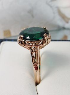 "Natural Treated Green Emerald Ring Edward Design#70z (smaller version) Rose Gold plated Sterling Silver Custom Made Inspired by Edwardian jewelry of the early 1900s, I now offer this lovely Antique reproduction ring in sterling silver rose gold plated. This gorgeous ring is set with a stunning approximately 3.6ct genuine Green Emerald gemstone (Color/Heat treated for clarity and saturation). (VS to Si1 clarity) The oval cut Emerald is 12mm (9/16th of an inch) Long by 10mm Wide (3/8th\"). The ri Victorian Style Gold Emerald Ring For Formal Occasions, Victorian Gold Emerald Ring, Victorian Style Collectible Emerald Ring, Victorian Emerald Ring In 14k Gold, Victorian 14k Gold Emerald Ring, Green Garnet Jewelry, Rose Gold Emerald Ring, Antique Emerald Ring, Emerald Ring Vintage