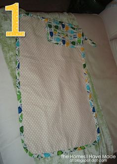 the number one quilt on top of a bed with white sheets and green polka dots