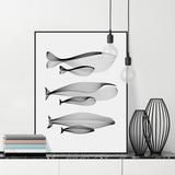 three black and white fish are displayed on a shelf next to a vase with books