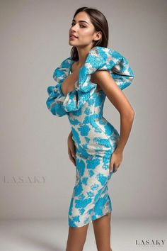 a woman is posing in a blue and white dress