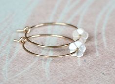 "Gold Filled Hoop Earrings, Tiny White Mother of Pearl Flower Hoop Earrings, Gold Hoop Earrings, Gold Earrings, Flower Hoops, Bridal Earrings, Gift for Her, Romantic Earrings, Feminine Earrings, Small Hoops, Dainty Earrings, MOP Earrings Adorable, feminine and lightweight 14k gold filled hoop earrings with the sweetest and tiniest carved white mother of pearl flowers. D E T A I L S: => Metal Type - 14k Gold Filled => Hoop size - Approx. 2 cm in diameter => Length - Approx 2 cm / 0.78\" Delicate Flower Charm Hoop Earrings, Dainty Hoop Earrings With Flower Charm, Dainty Hoop Flower Earrings Gift, Delicate Hoop Jewelry With Flower Charm, Delicate Yellow Gold Hoop Earrings, Dainty Hoop Jewelry With Flower Charm, Dainty Flower-shaped Hypoallergenic Hoop Earrings, Delicate Hoop Earrings With Flower Charm, Dainty Hypoallergenic Flower Hoop Earrings