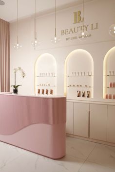 the inside of a beauty store with pink counter