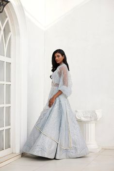 Geometric mirror and leather applique embroidered skirt in silver on grey dupion silk fabric paired with a halter blouse and tulle dupatta with scallop border and pearls and sequence detailing.From Chamee and Palak's The Romantics collection.DELIVERY TIMEPlease allow 8-12 weeks for your outfit to arrive.FABRIC DETAILSSilk, NetProfessional cleaning only. Evening Gown With Resham Embroidery In Organza, Evening Gown With Resham Embroidery On Organza, Evening Anarkali Set With Zari Work In Organza, Festive Saree Gown With Pearl Embroidery, Festive Saree-shaped Gown With Pearl Embroidery, Festive Tissue Silk Dresses With Pearl Embroidery, Chanderi Sequined Sets For Reception, Organza Gown With Pearl Embroidery For Party, Floor-length Party Wear Sets With Pearl Embroidery