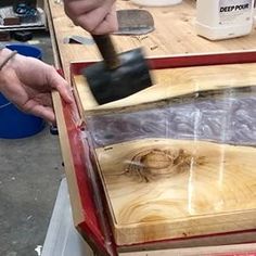 a person using a hammer to cut wood