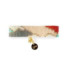 the multicolored beaded bracelet has a gold charm and is attached to it